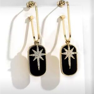 Black background gold tone star with crystal embellishments earrings